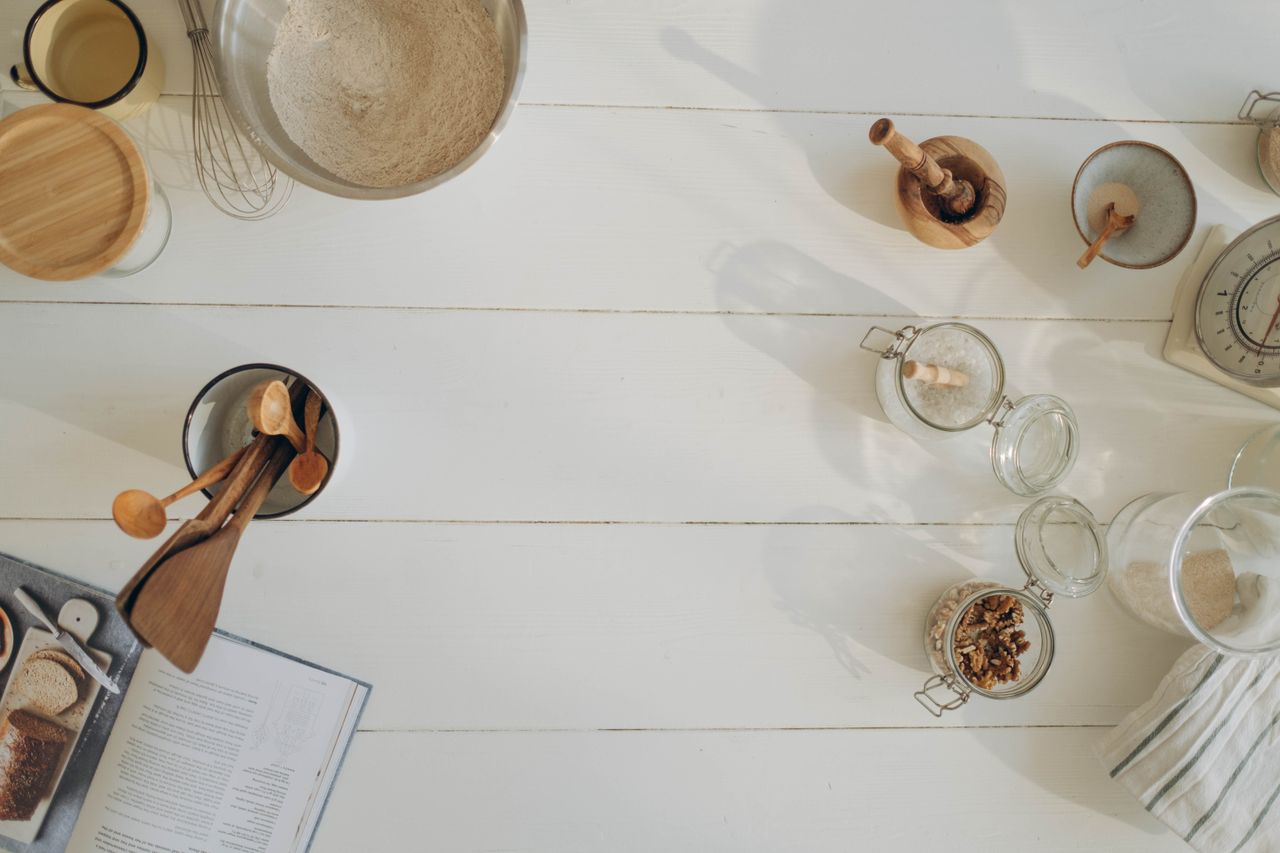 About Flat lay of rustic baking ingredients and tools on a wooden countertop, perfect for culinary inspiration.